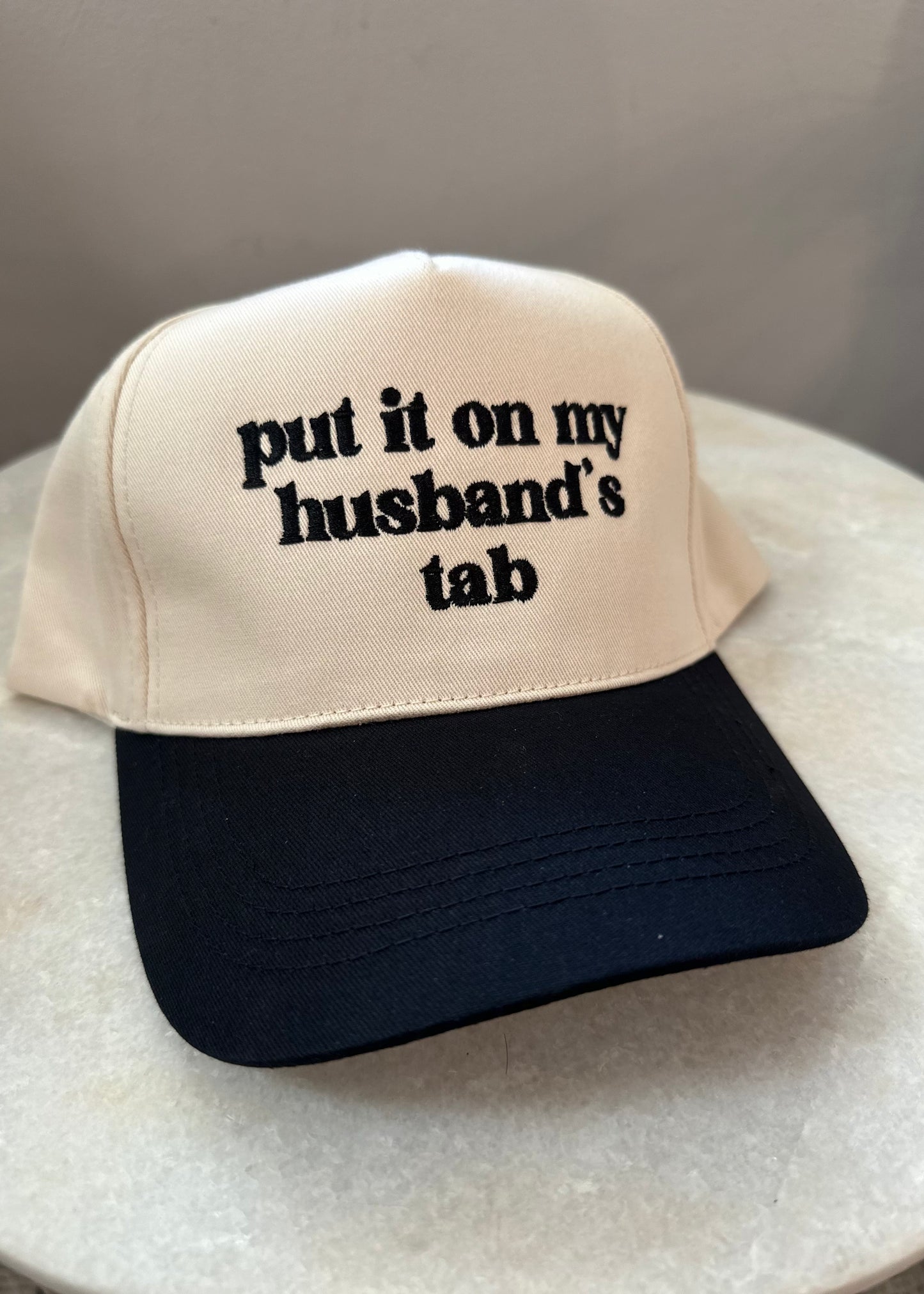 Put It On My Husbands Tab Trucker Hat